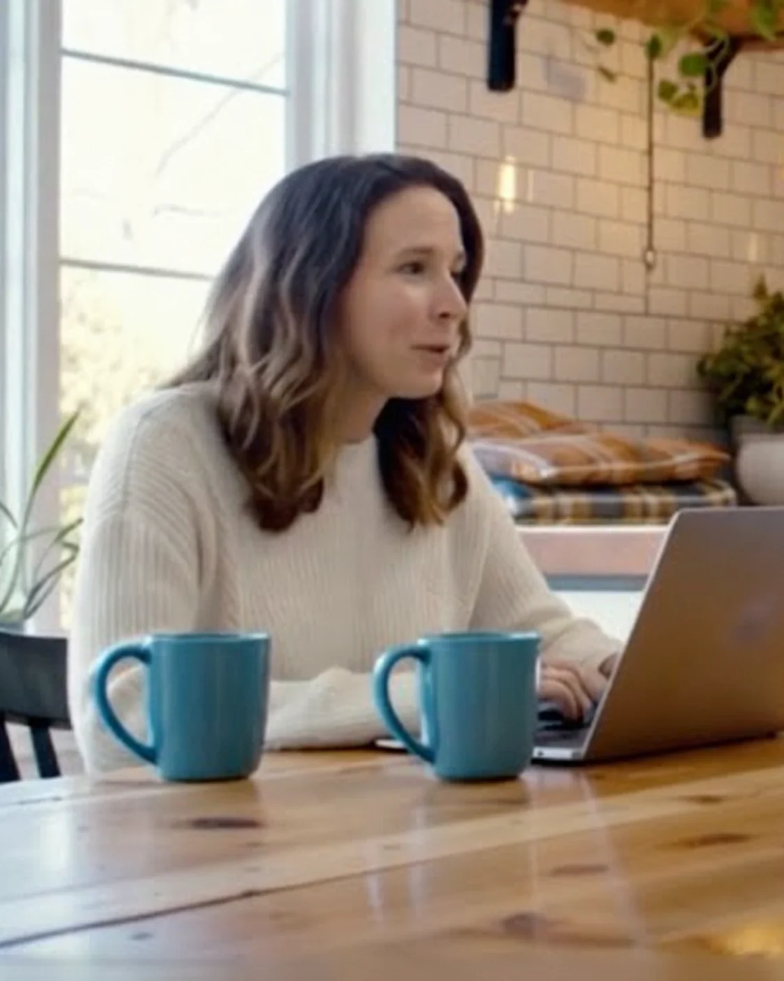 Minnesota parent working through a parenting time schedule in a virtual mediation session at a kitchen table